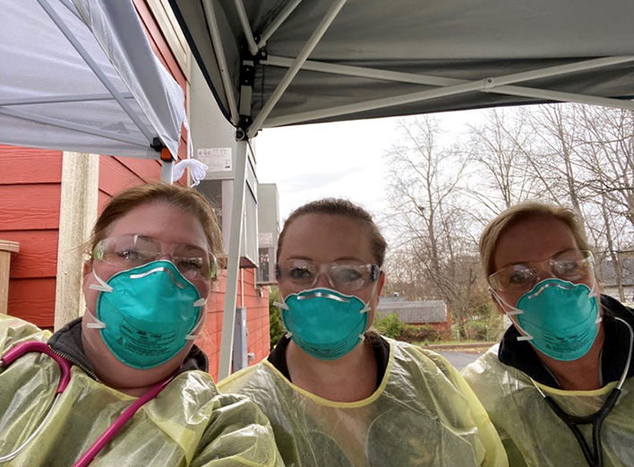 3 faculty staff members with PPE gowns masks goggles outside MAP clinic